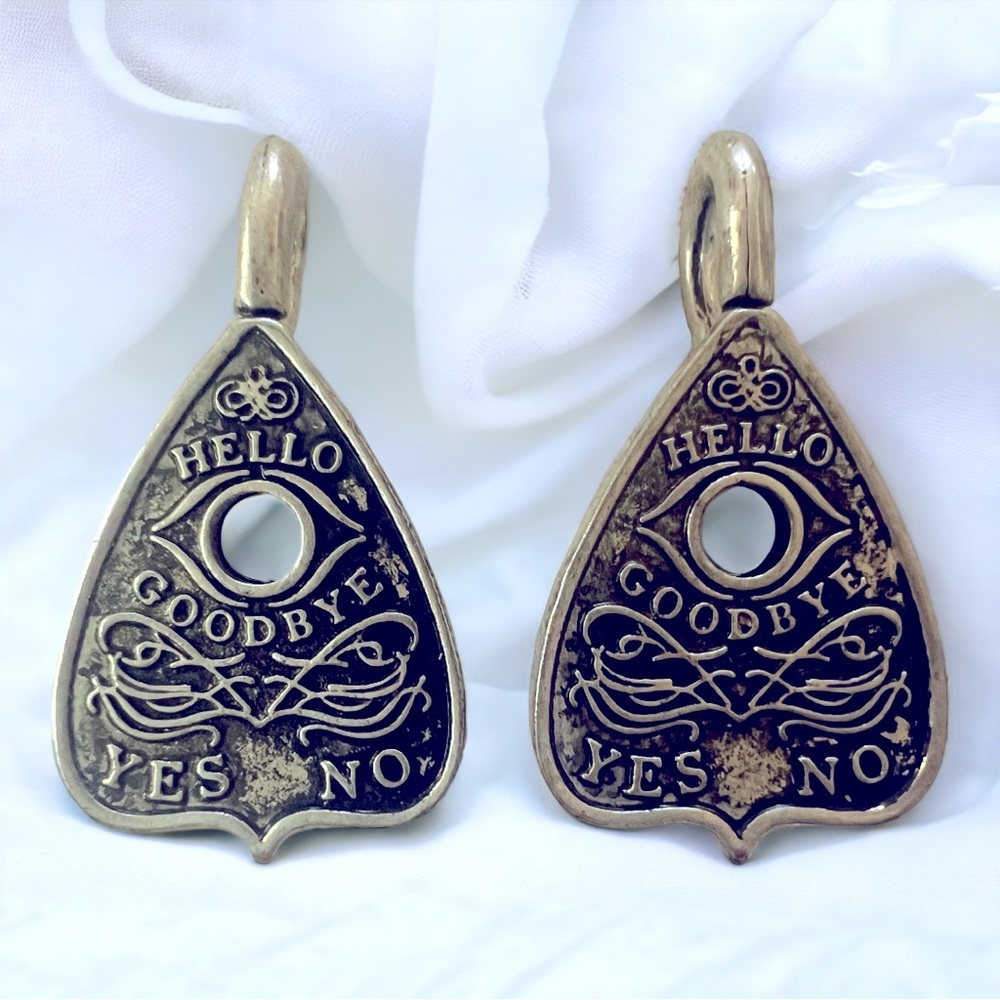 Silver Ouija board planchette earrings.